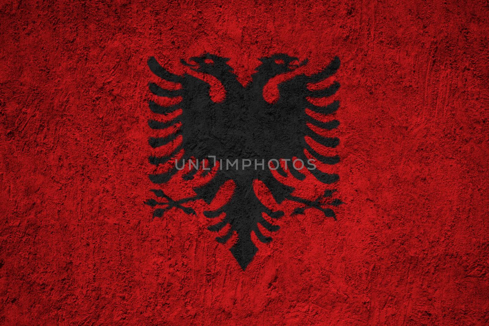 Albania flag painted on the cracked grunge concrete wall