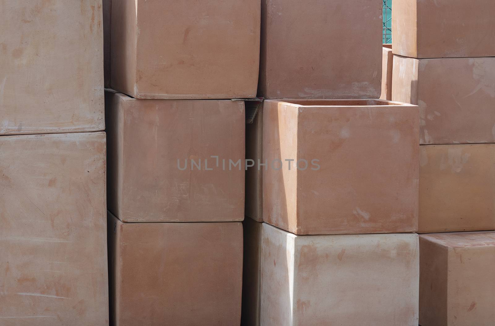 Rustic terracotta pots cube shape piled up on display closeup full frame