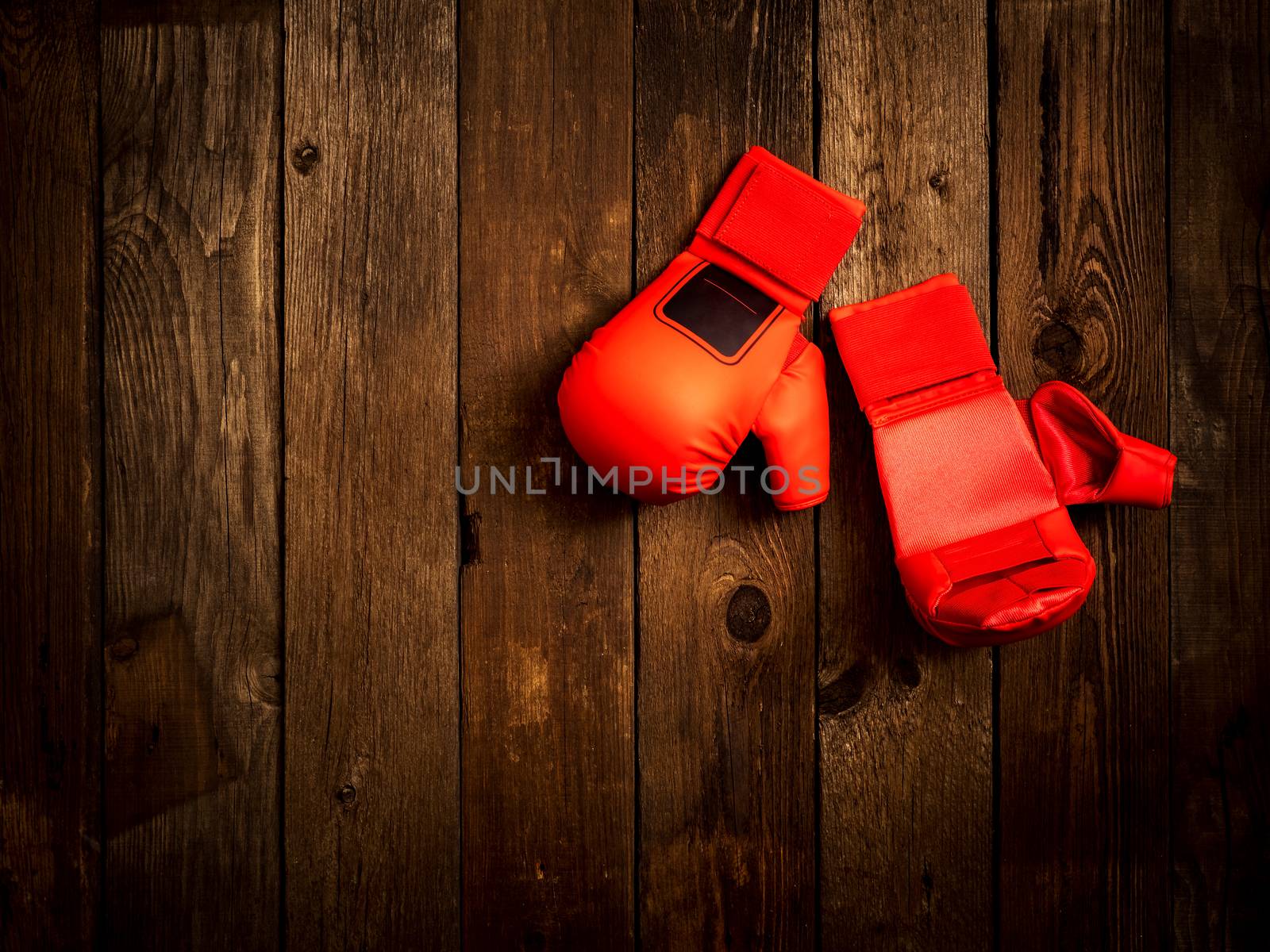 Leather karate gloves on the wooden background. Top view by eskamilho