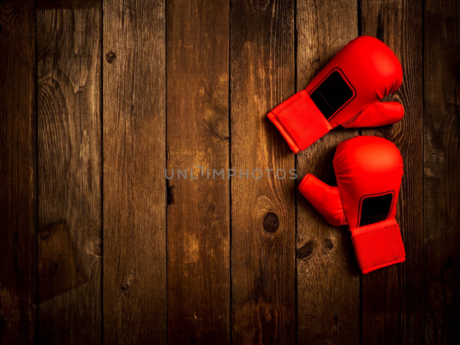 Pair of leather karate gloves lying on the wooden table