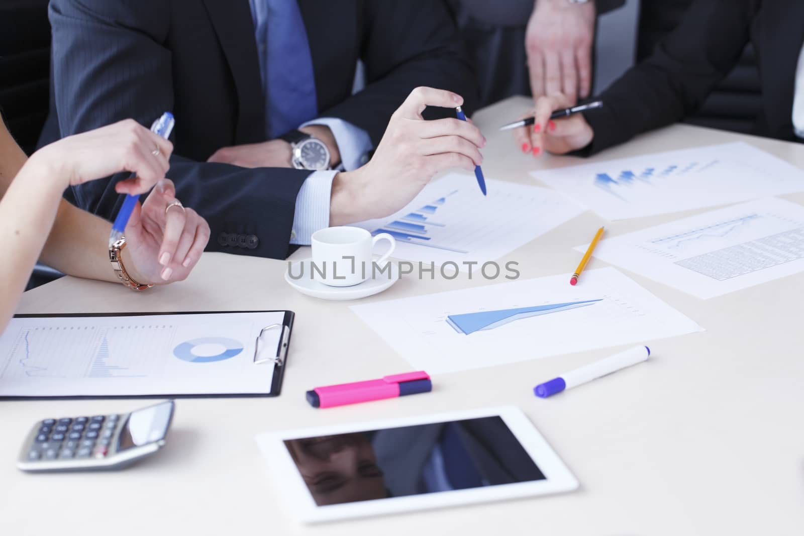 Working business people analyzing financial reports in office