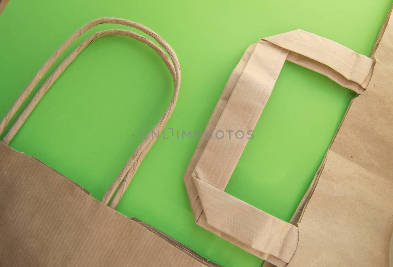 Zero waste, plastic free recycled production bag into paper bag, environmental protection concept, top view, green background, flat lay by claire_lucia