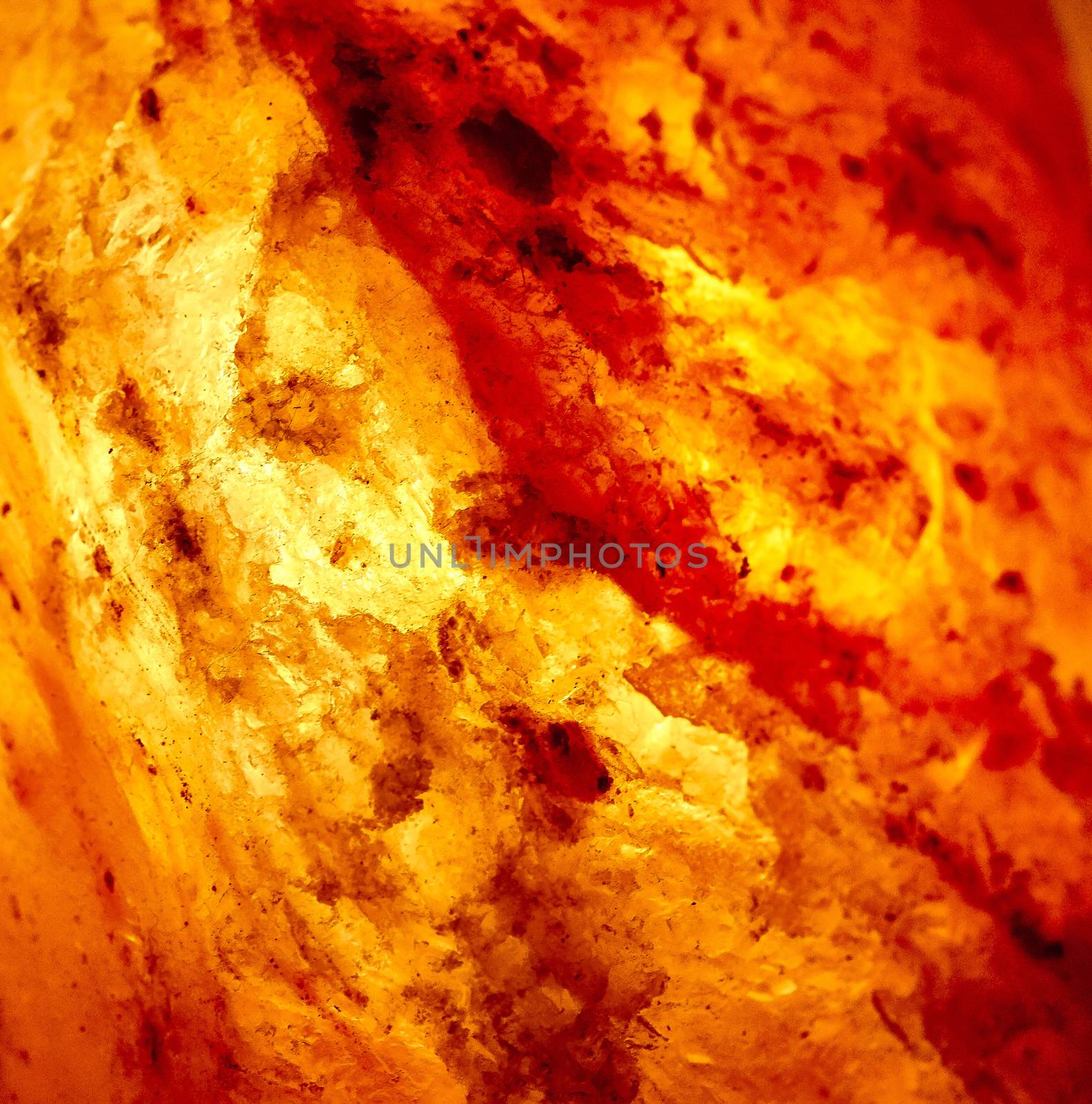 Detail of a lit salt lamp showing salt crystals by pippocarlot