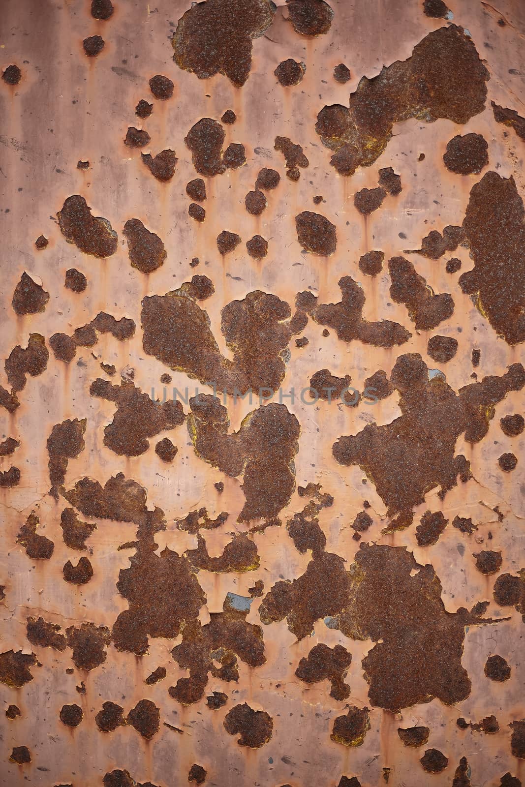 Texture of a sheet painted with rust stains and the paint that is flipping through