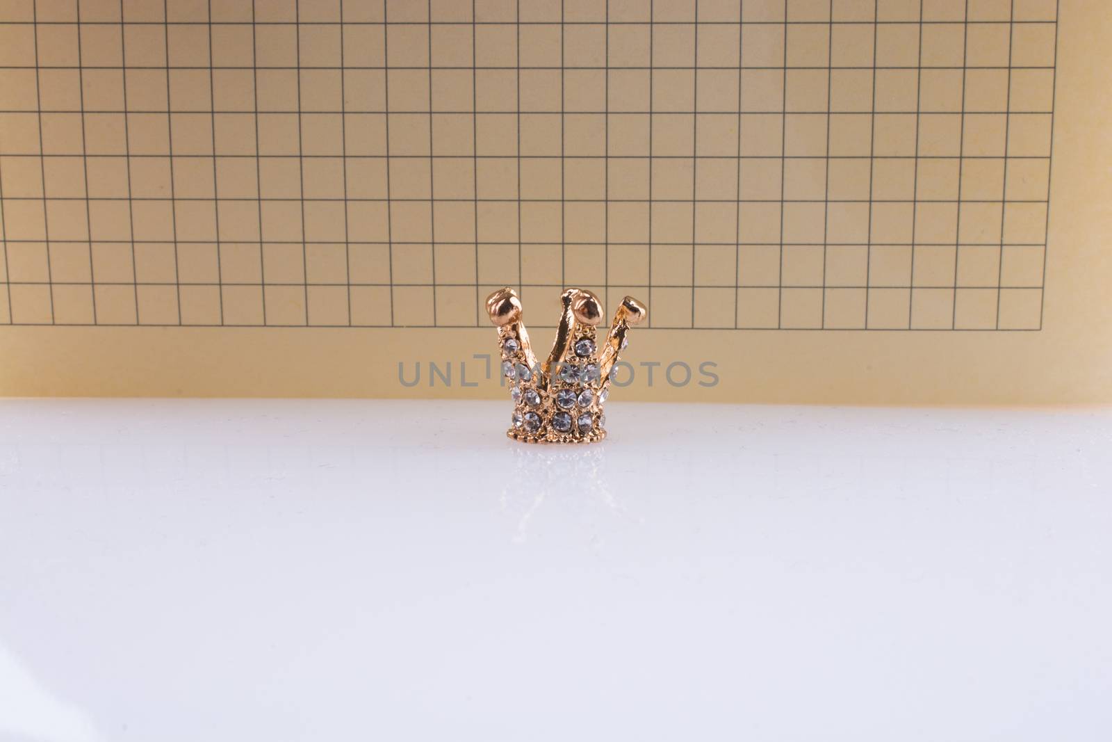 Crown with a notebook on a white background