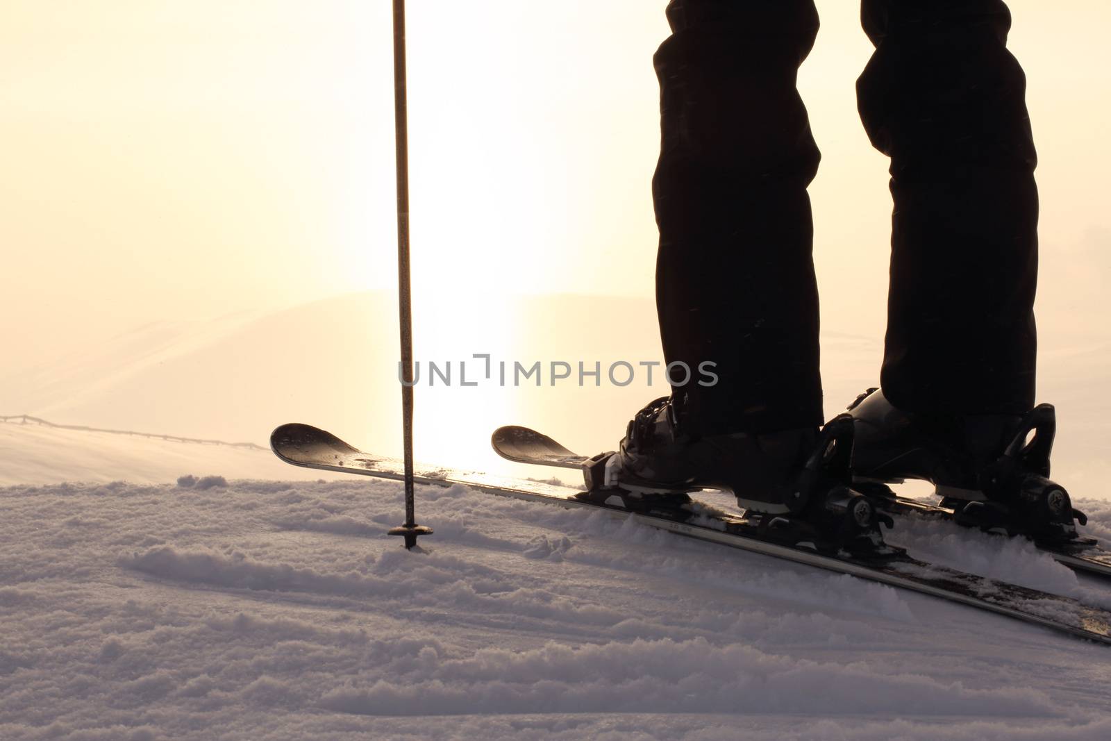 Skier on ski slope with mountains in background