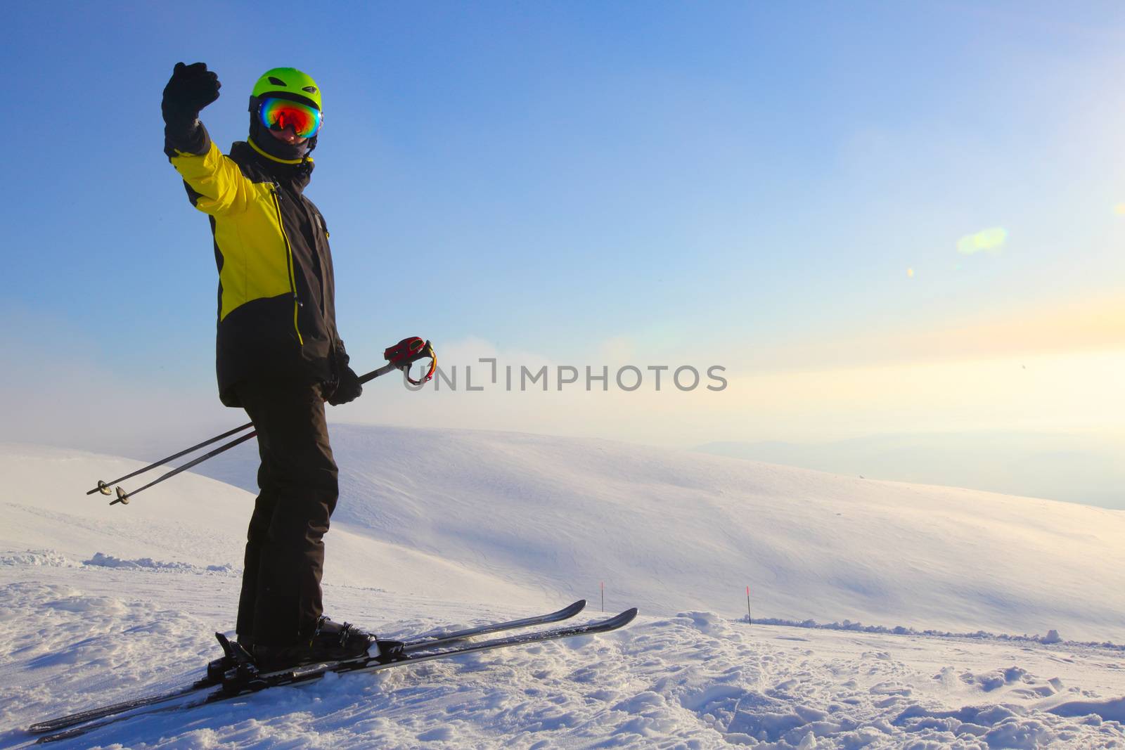 Skier on ski slope with mountains in background