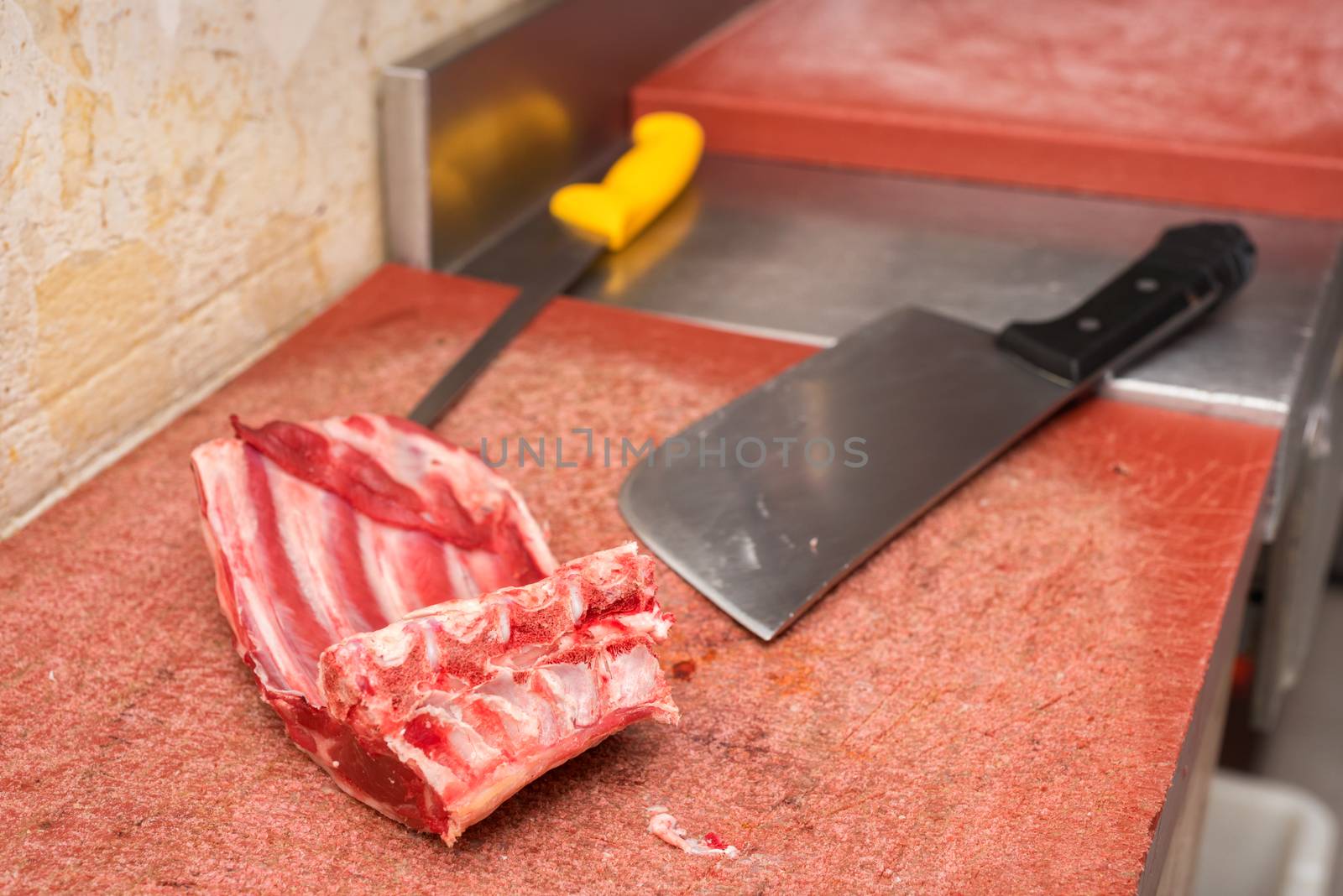 piece of meat and knife on the butcher's table by HERRAEZ