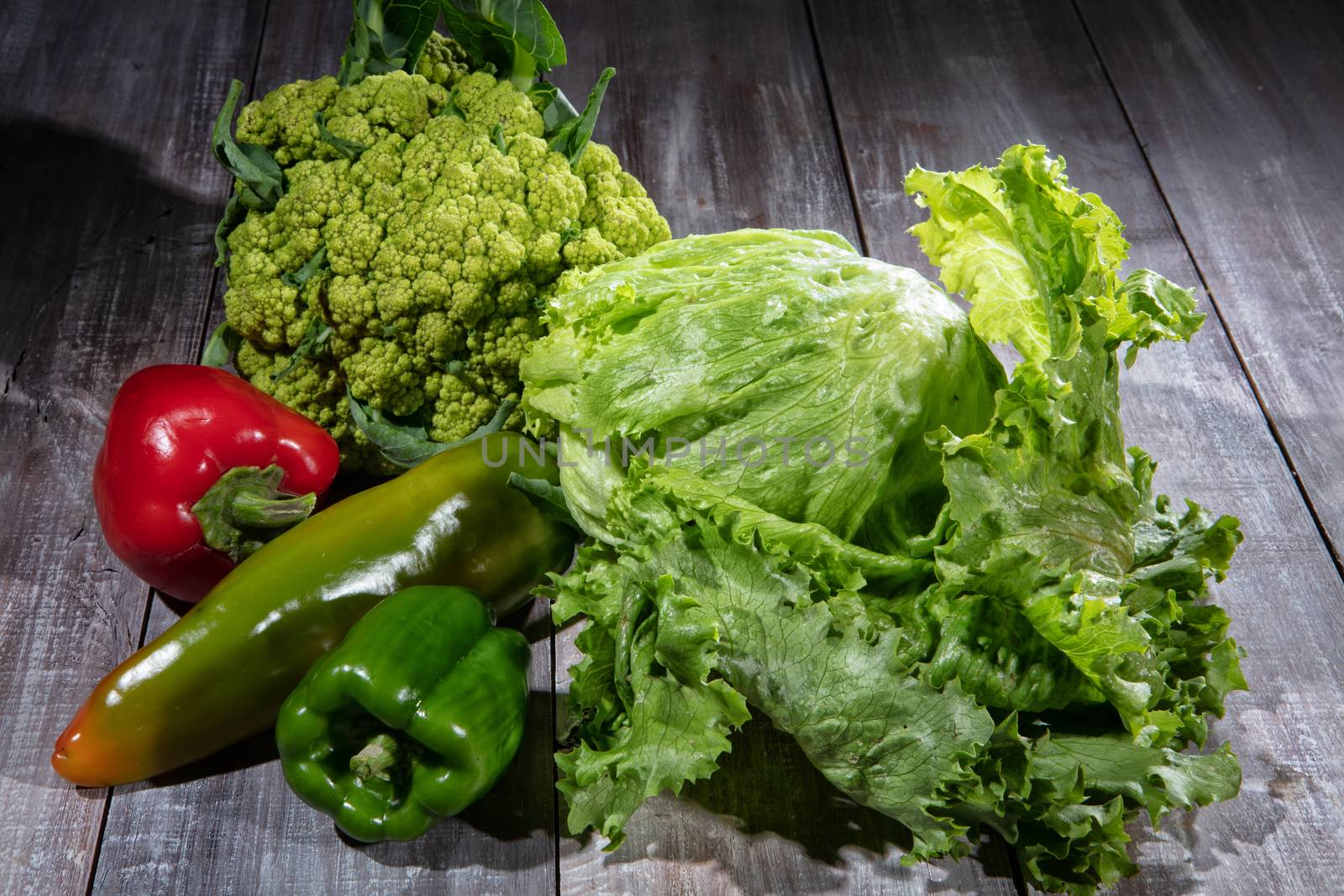 Cabbage and vegetables on an old wooden desk