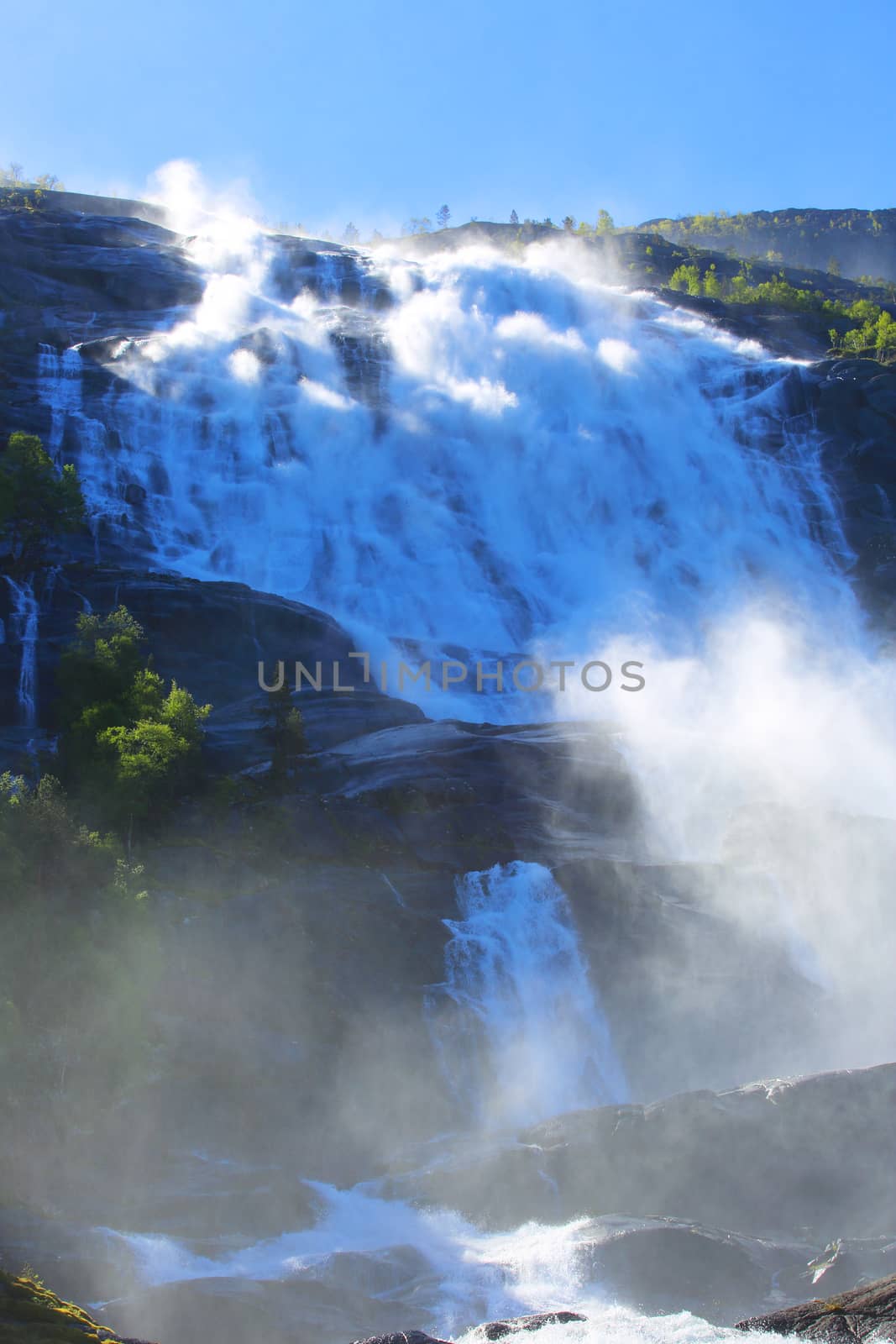 Langfossen waterfall in summer by destillat