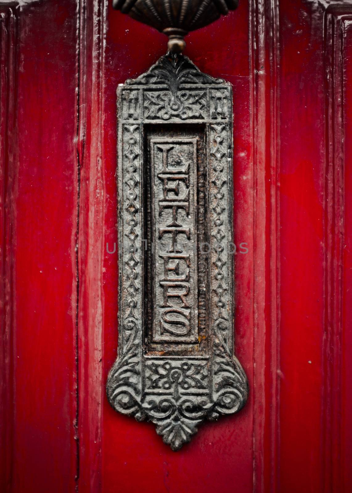 Ornate Old Fashioned British Letterbox Or Mailbox On A Red Front Door