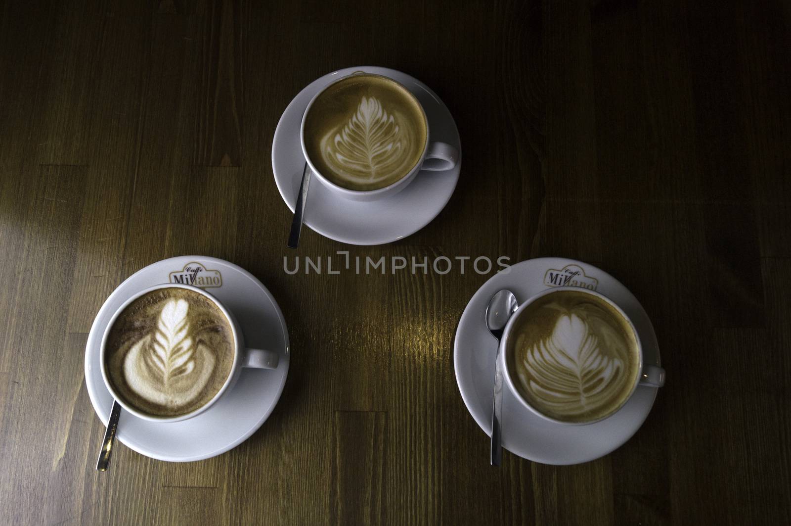 three cups ready to be served coffee with milk by sonyugur