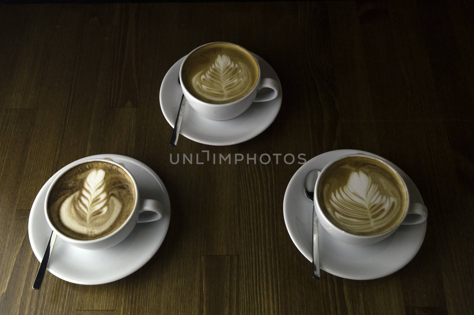 three cups ready to be served coffee with milk by sonyugur