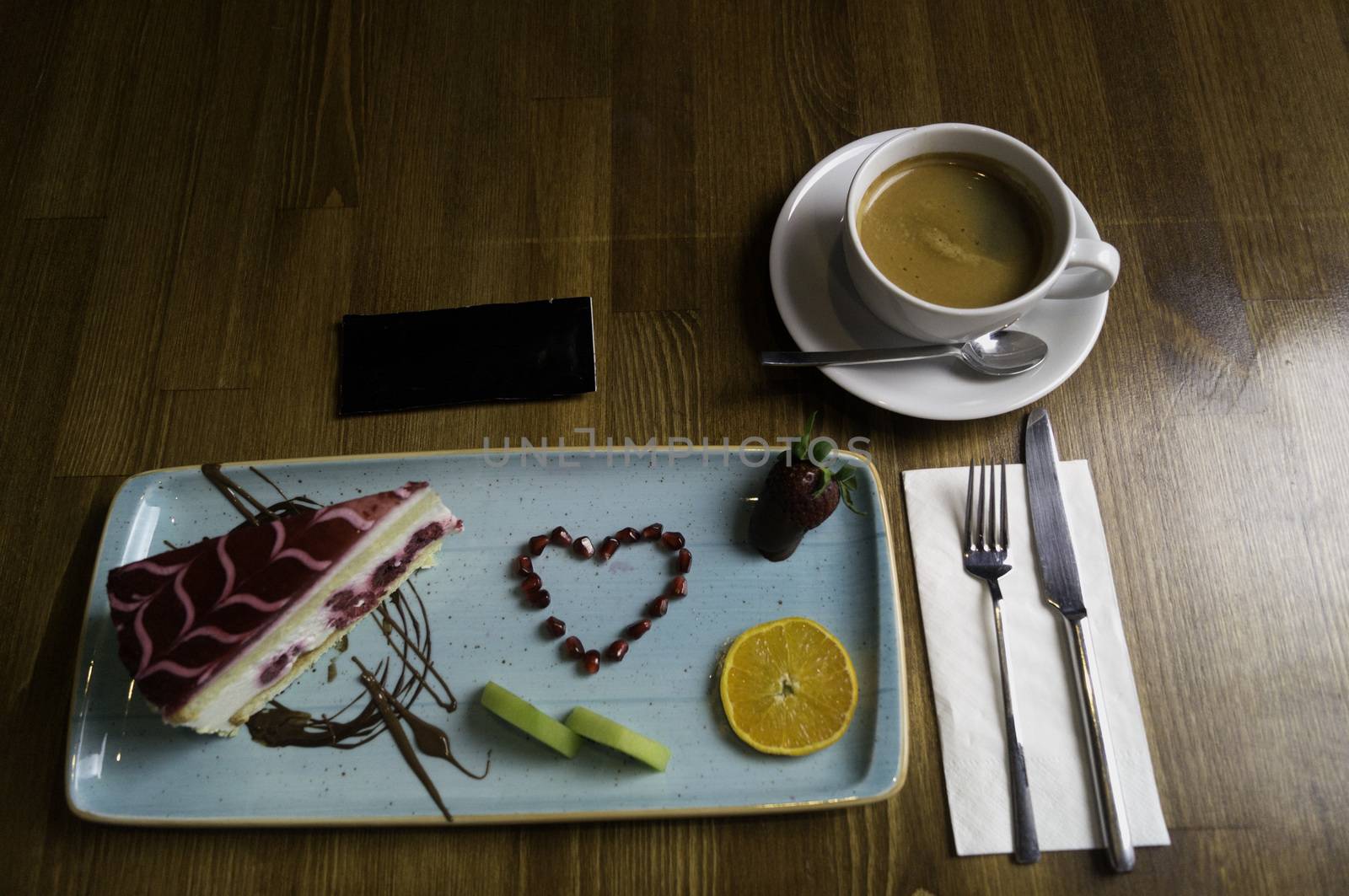 tray stands on sliced chocolate cake and drink by sonyugur