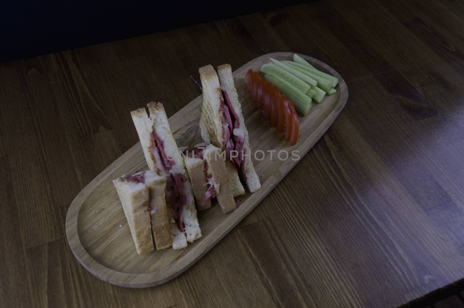 sliced cheddar and sausage toast cucumber tomato prepared for breakfast