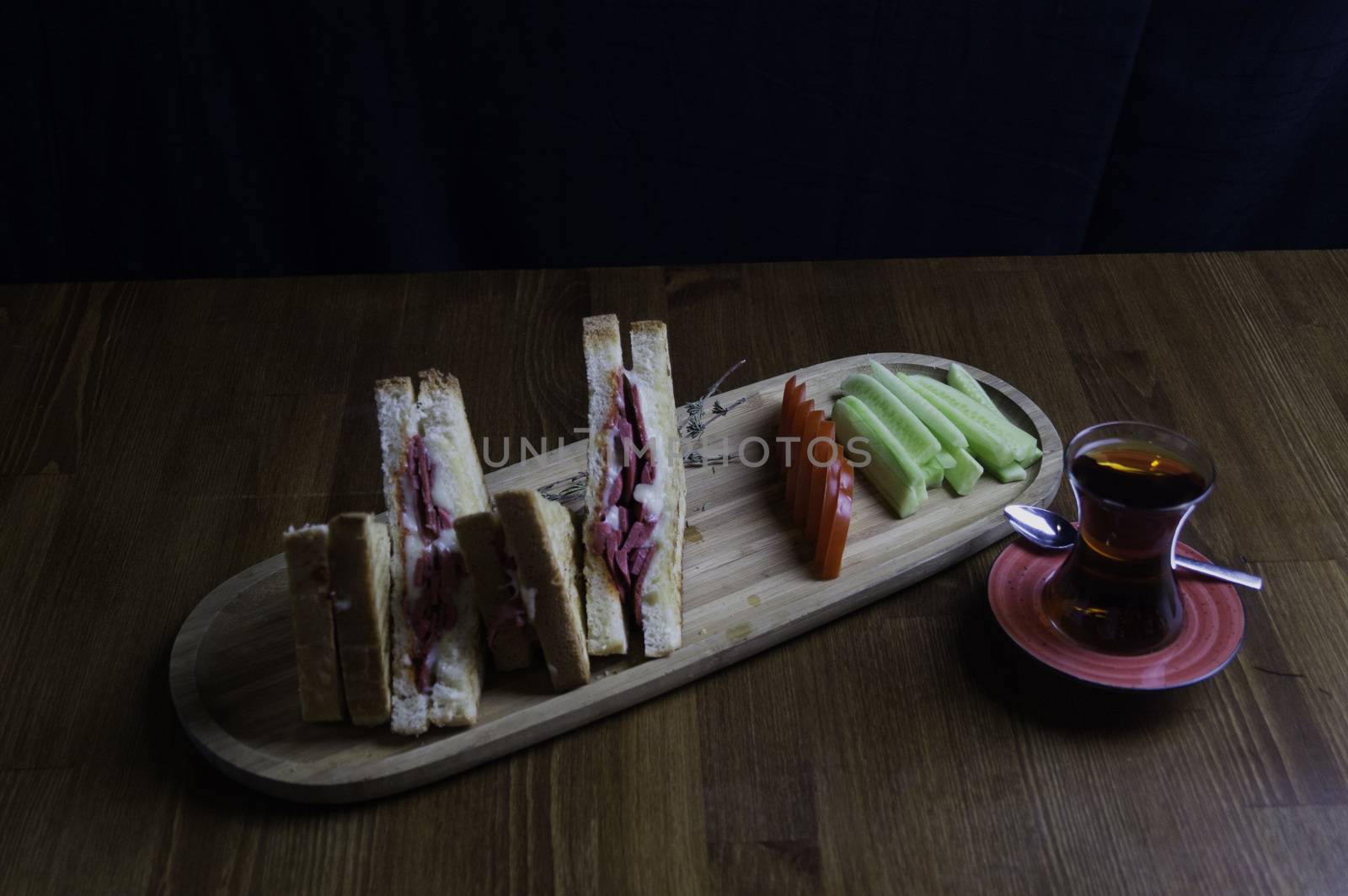 sliced cheddar and sausage toast cucumber tomato tea prepared for breakfast