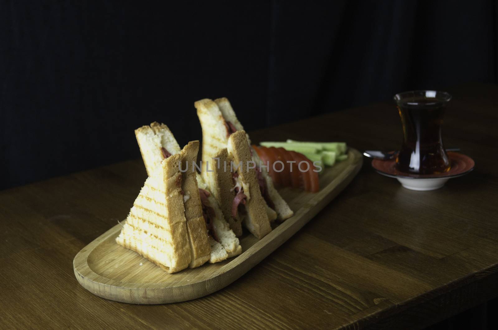 sliced cheddar and sausage toast cucumber tomato tea prepared for breakfast