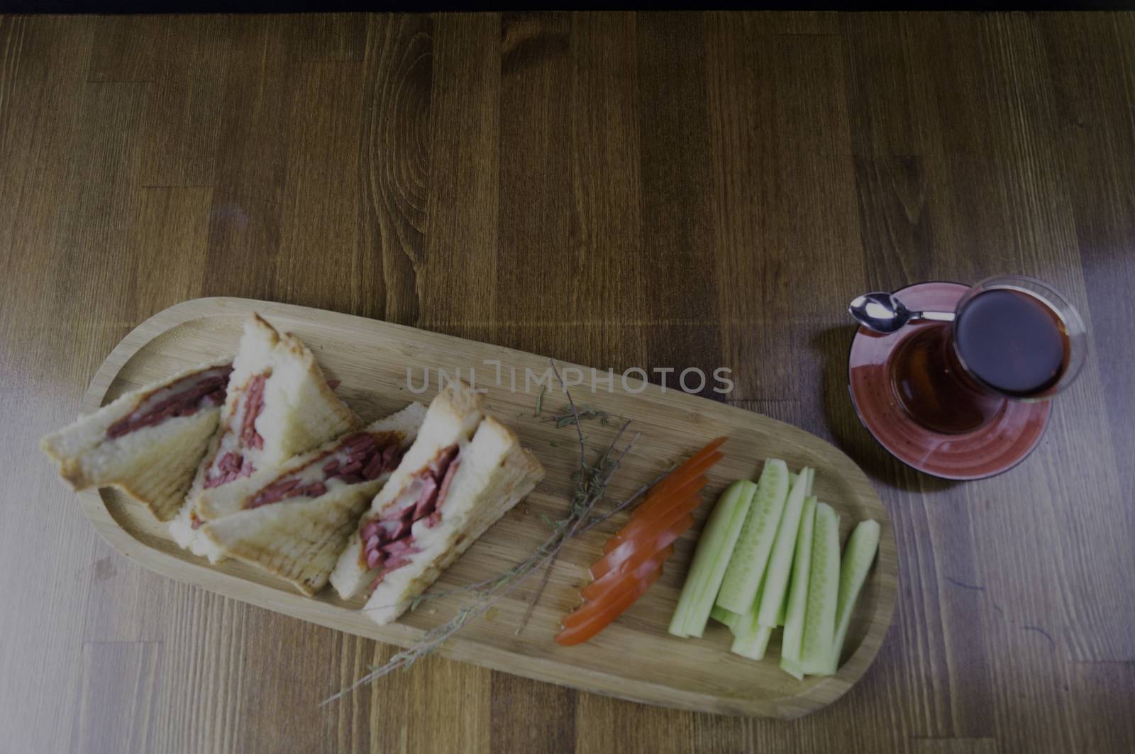 sliced cheddar and sausage toast cucumber tomato tea prepared for breakfast