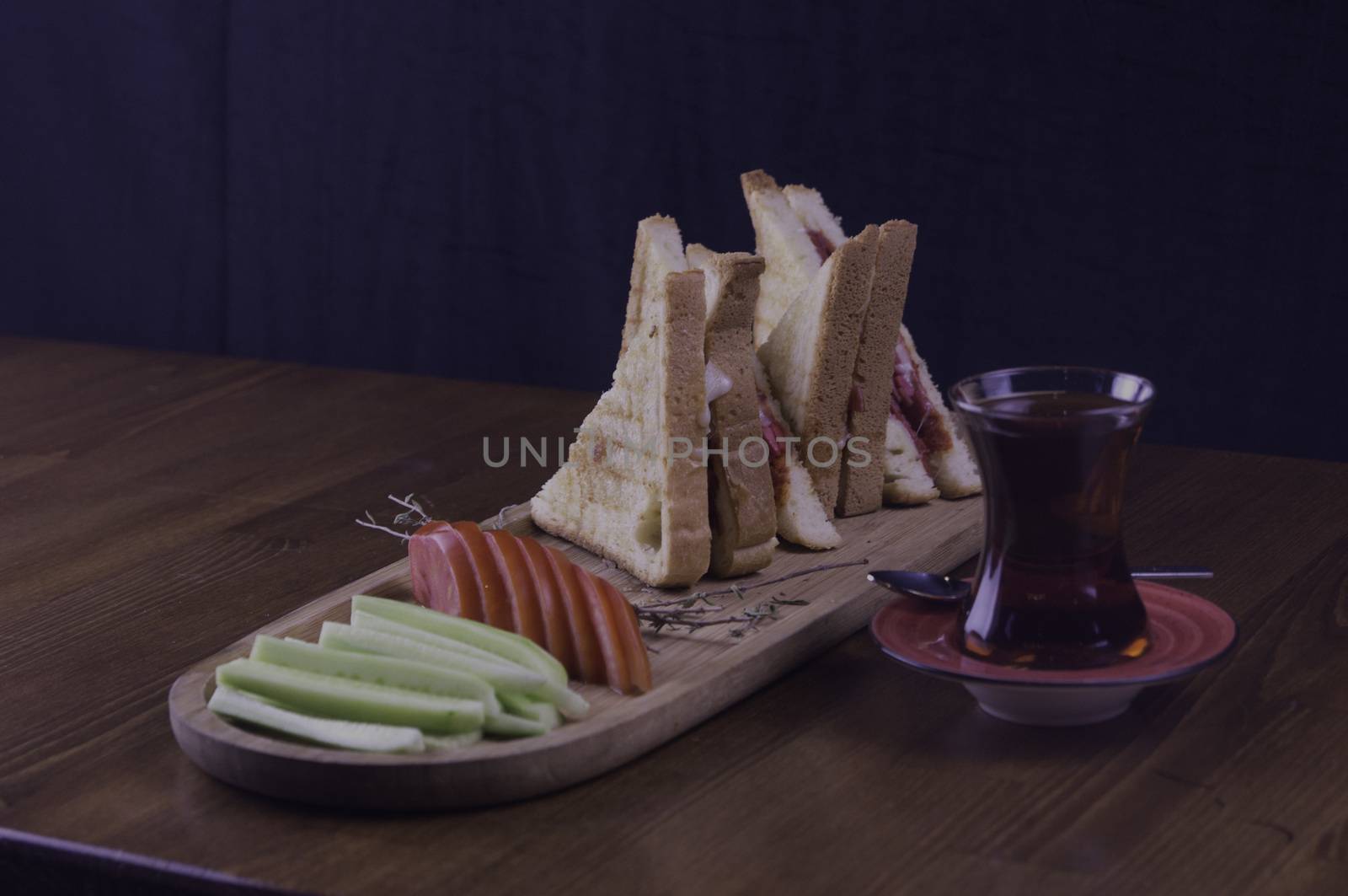 sliced cheddar and sausage toast cucumber tomato tea prepared for breakfast