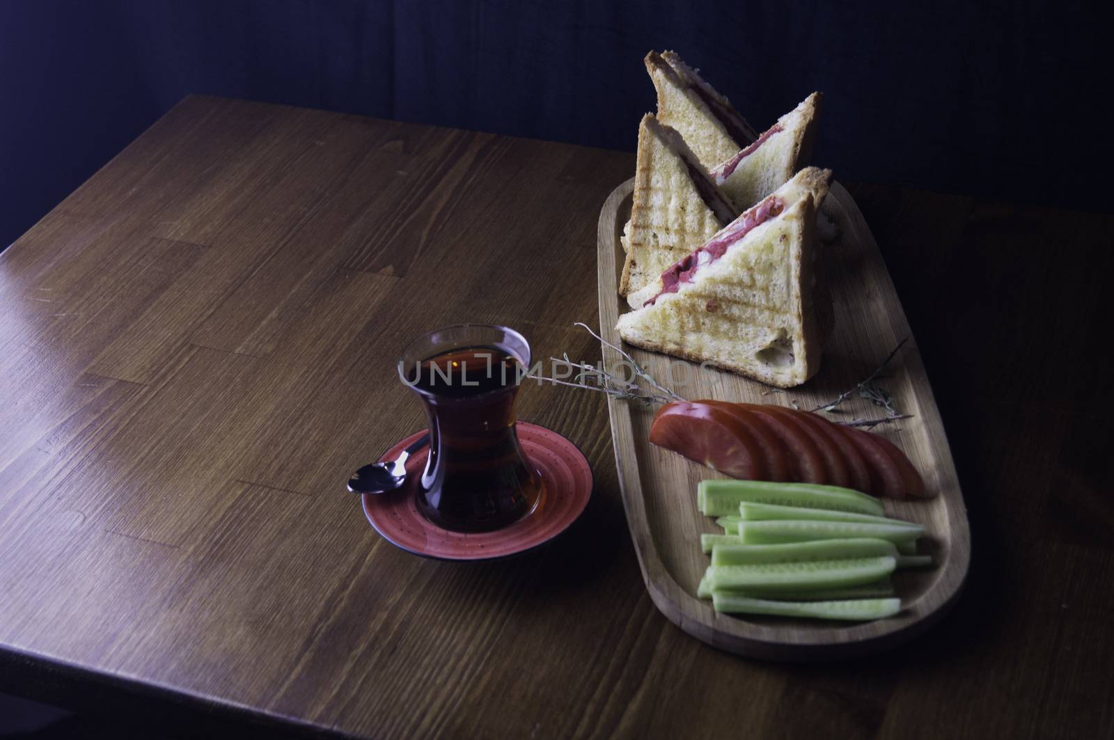 sliced cheddar and sausage toast cucumber tomato tea prepared for breakfast