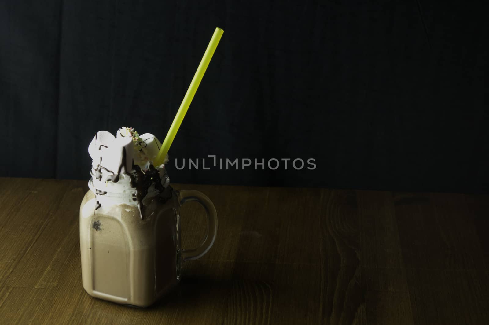 Candy flavoring with chocolate drinks in glass cups with handles placed