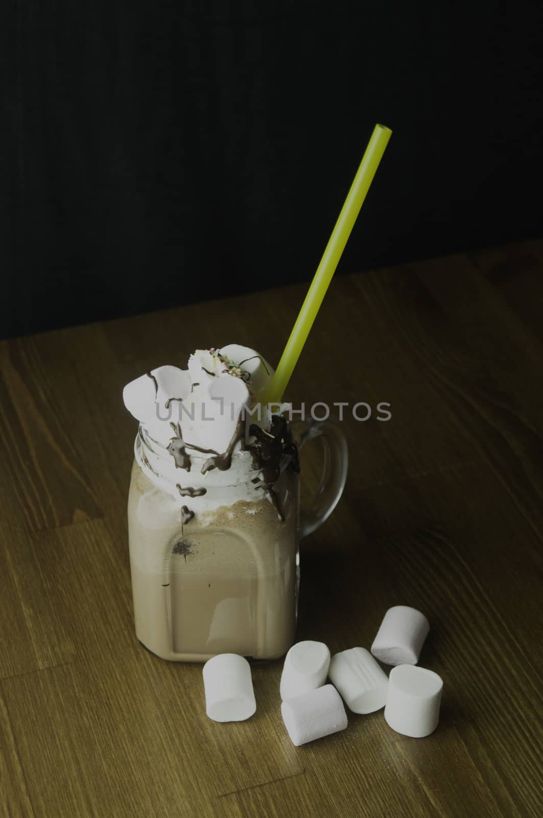 Candy flavoring with chocolate drinks in glass cups with handles placed