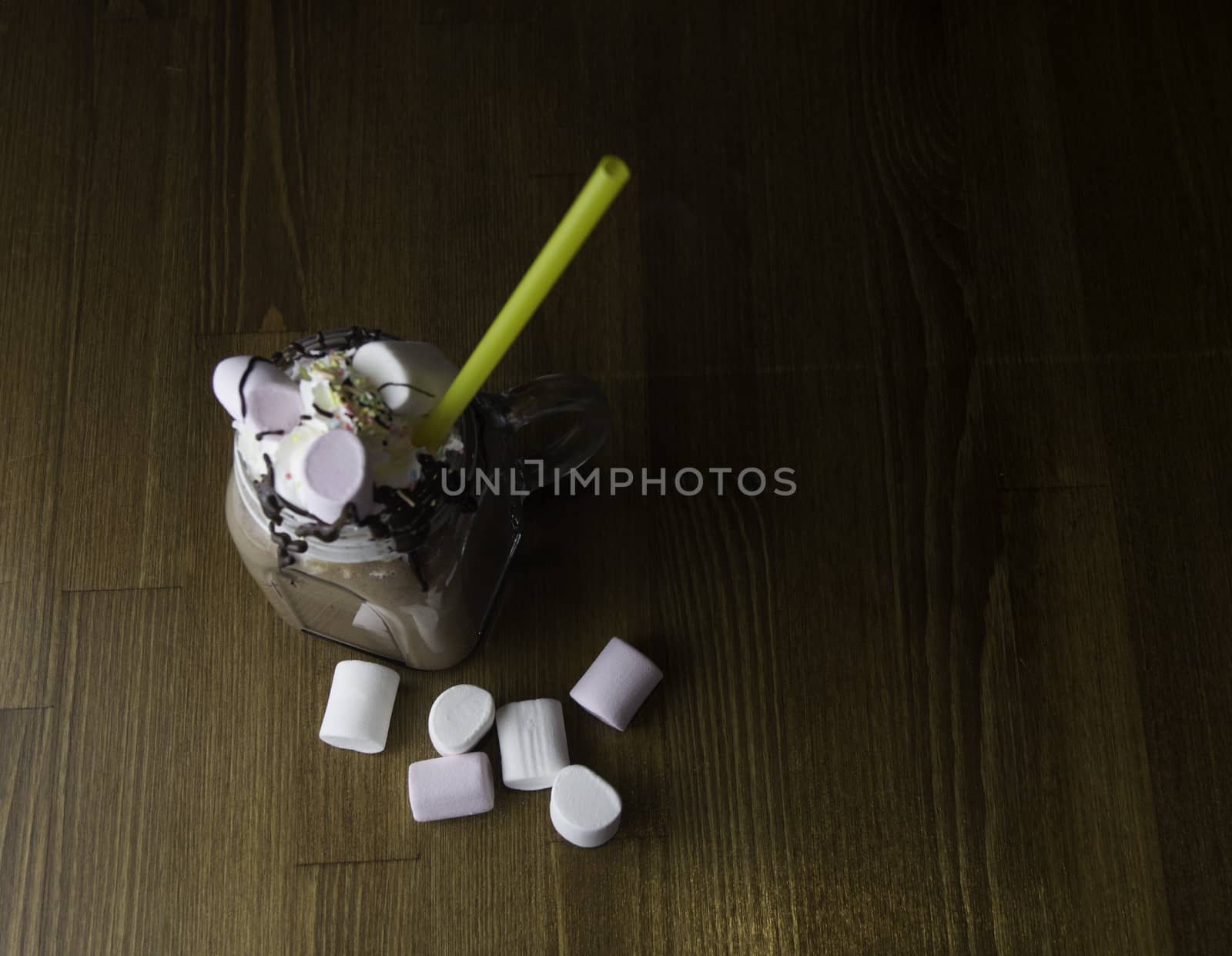 Candy flavoring with chocolate drinks in glass cups with handles placed