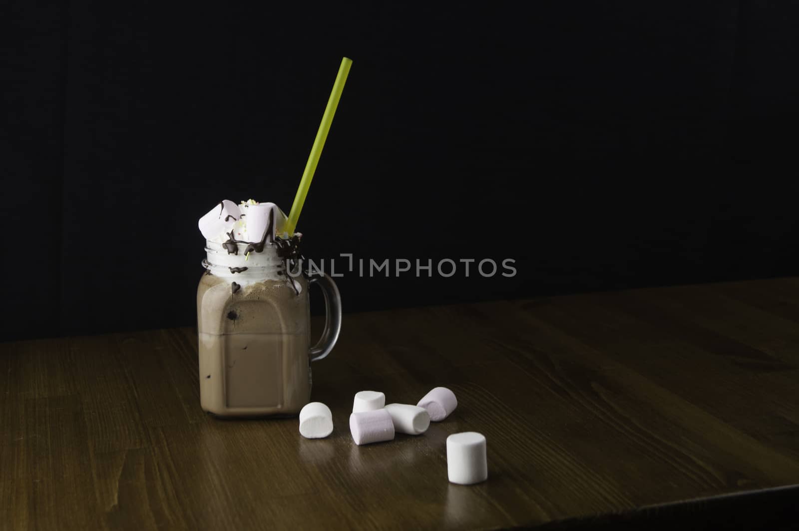 Candy flavoring with chocolate drinks in glass cups with handles placed