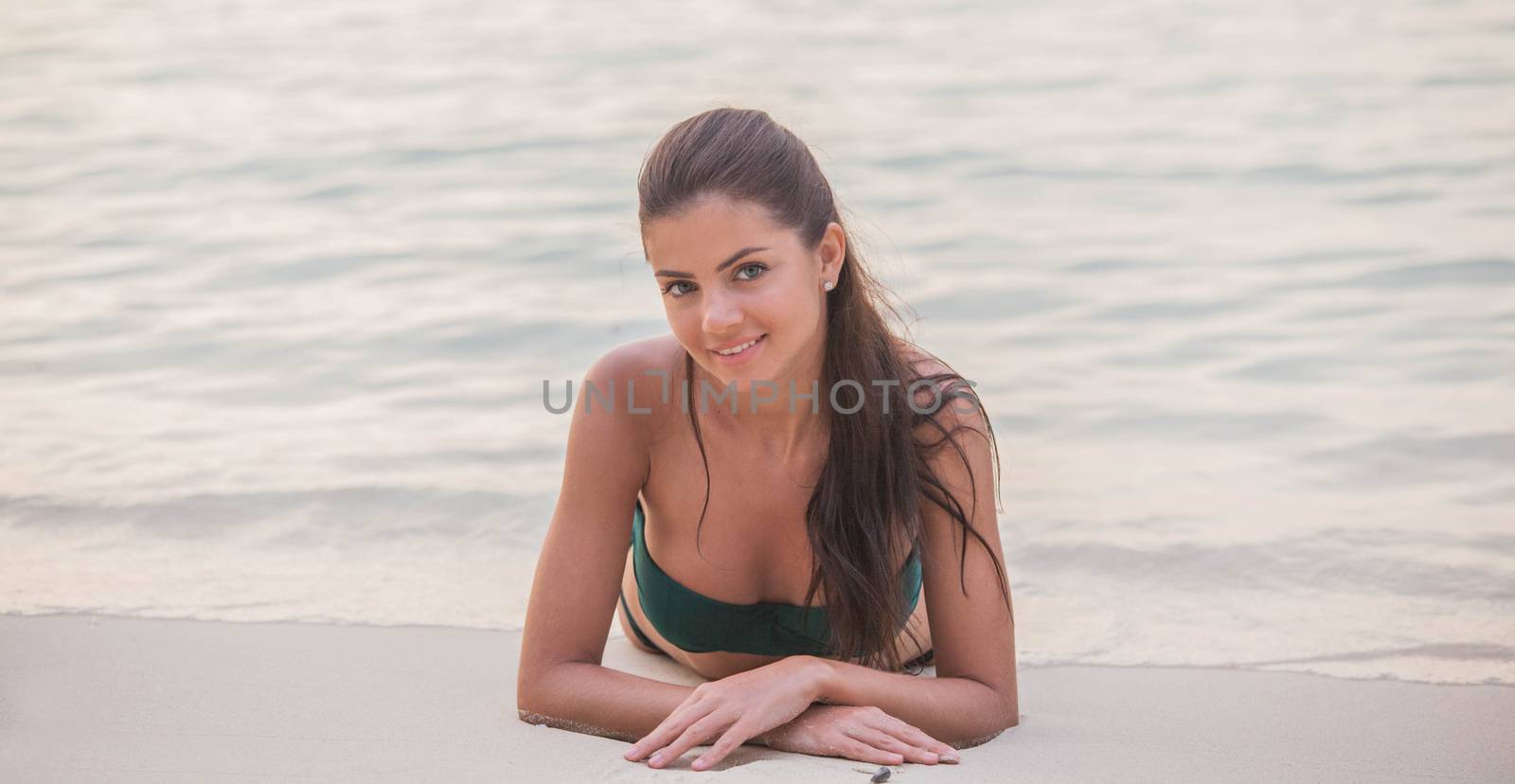 Woman in bikini relaxing on the beach at sunset time. Travel in Thailand, Summer and vacation concept