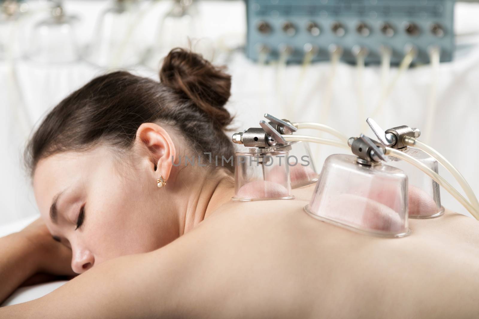 Beautiful woman relaxing with vacuum body massage by sveter