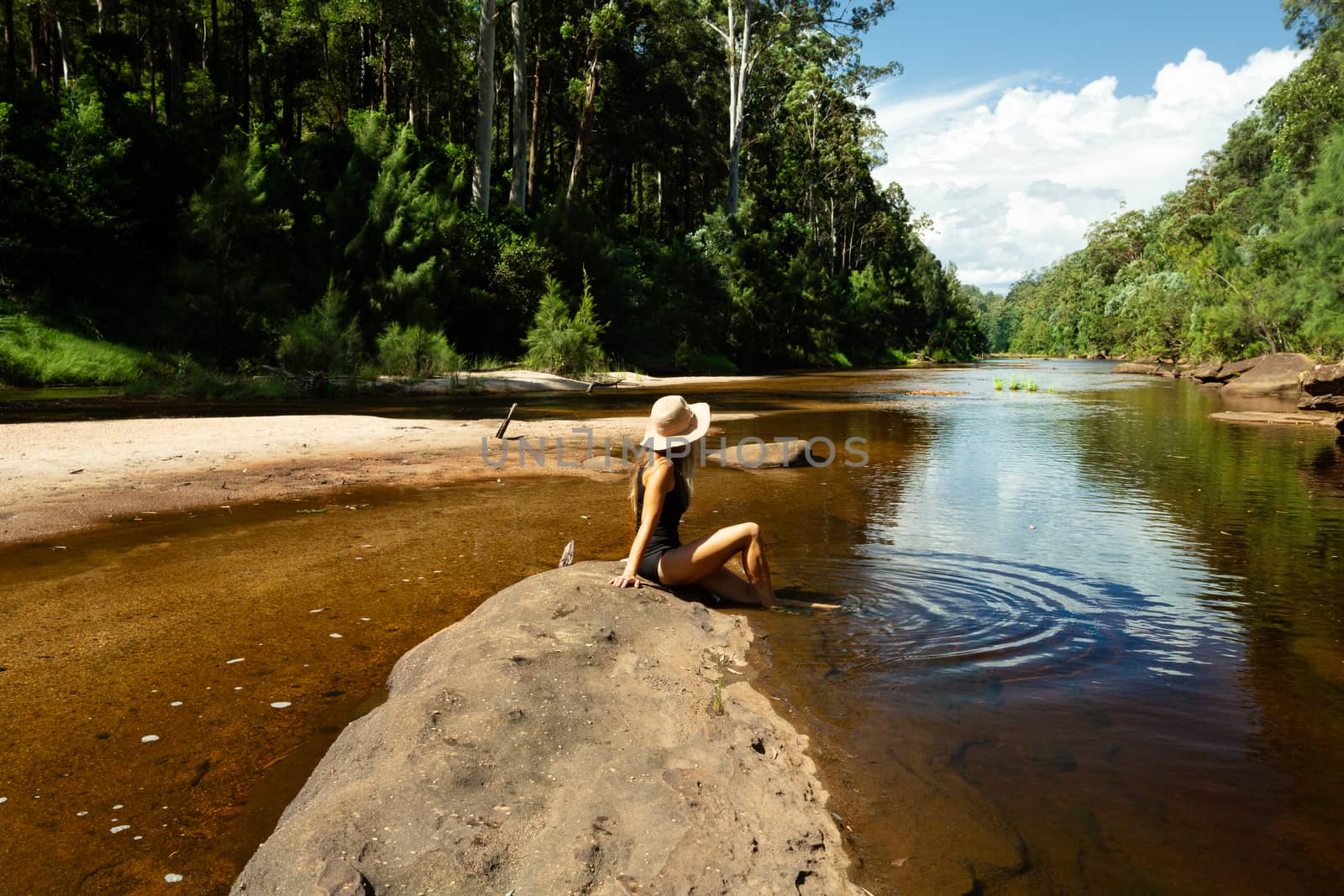 Woman relaxing along the shallows of the Grose River by lovleah