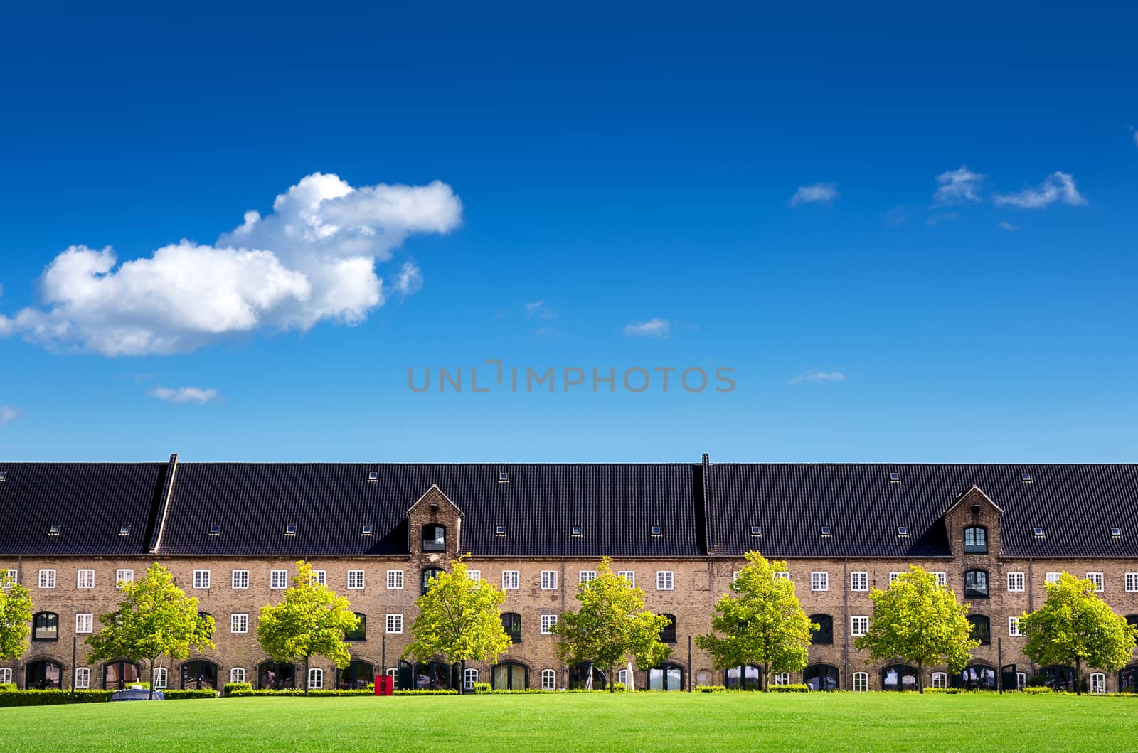 Classic and beautiful apartment, danish style, with clear blue sky and grass lawn in Copenhagen Denmark, Europe