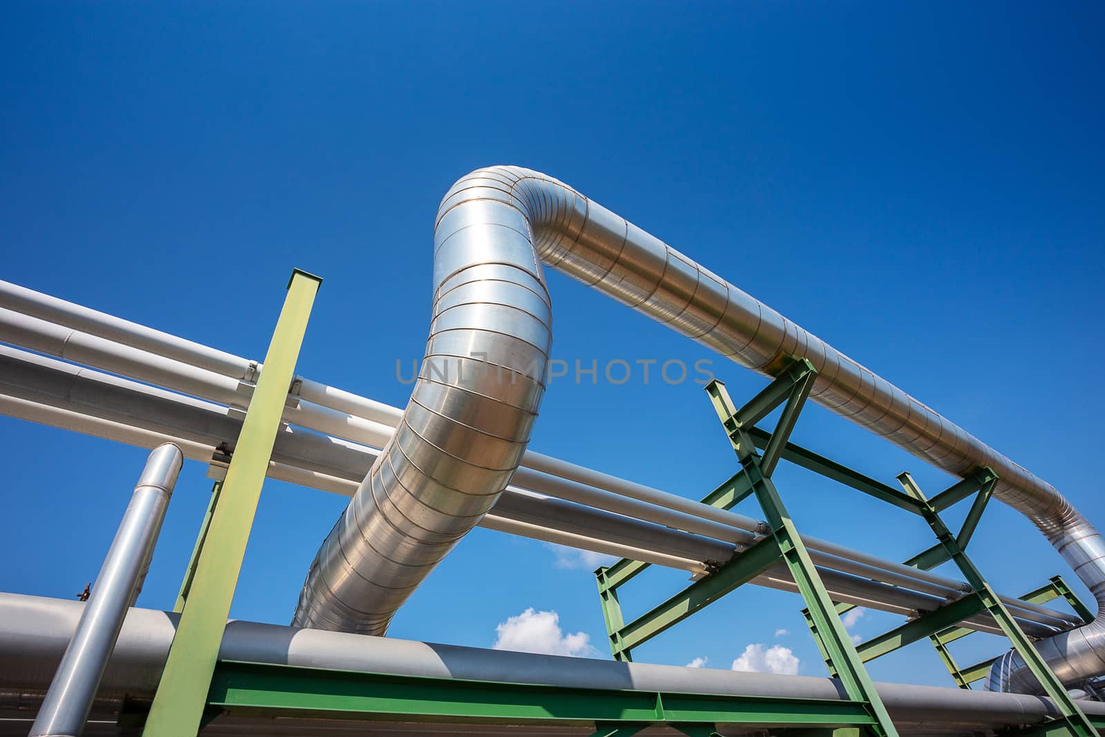 insulation of steam pipe for steam transportation on lack in industrial zone with clear blue sky