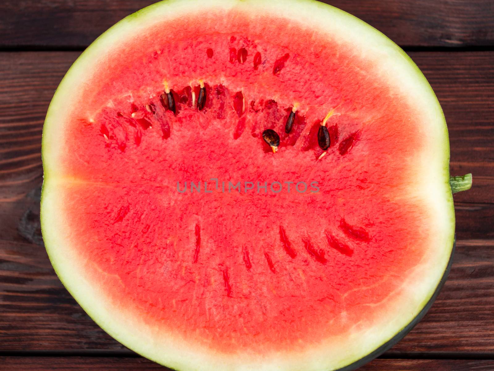 Surface of the half of a ripe red watermelon closeup, texture.