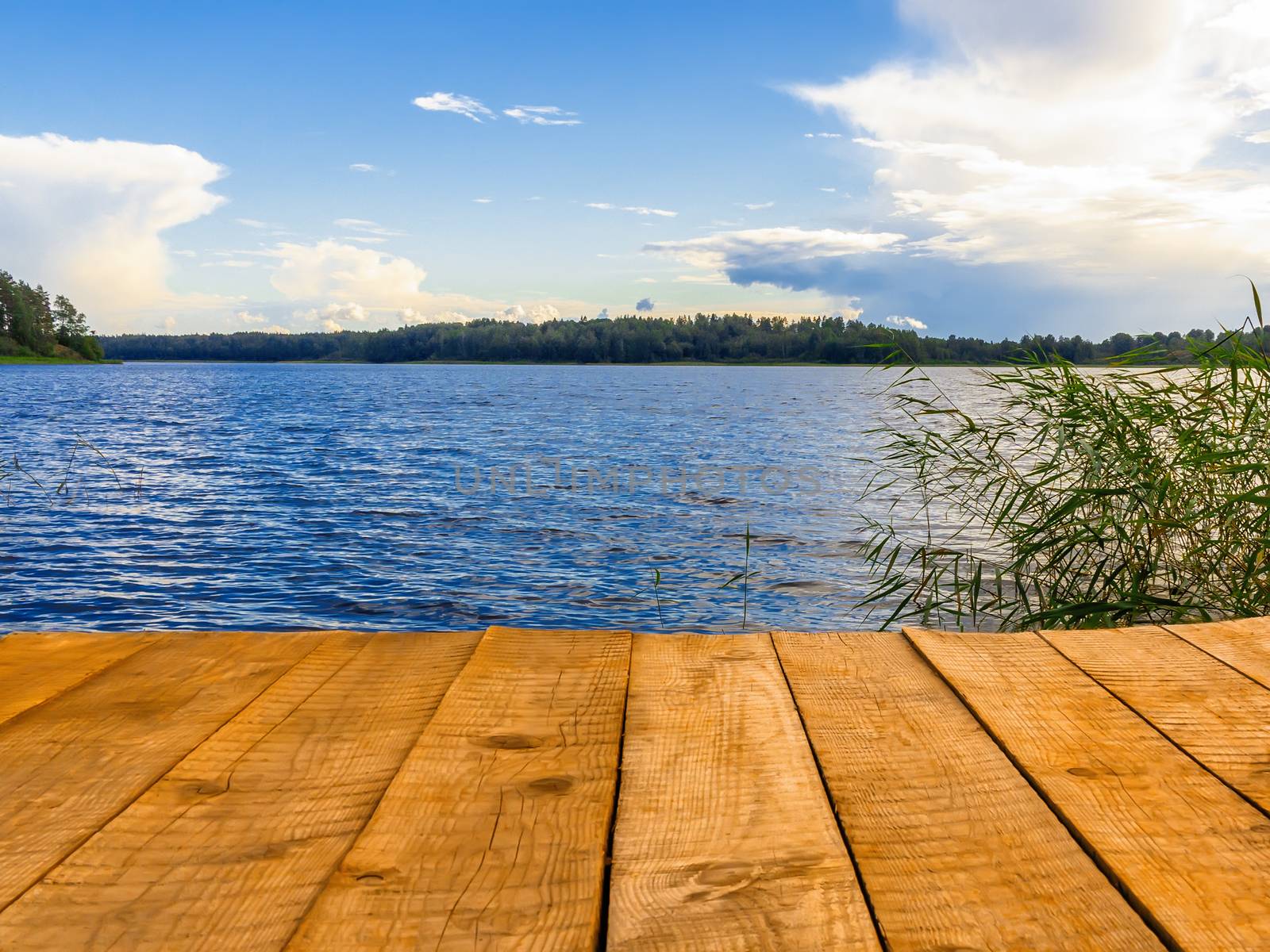 Empty wooden pier for swimming, boats or fishing on the lake.