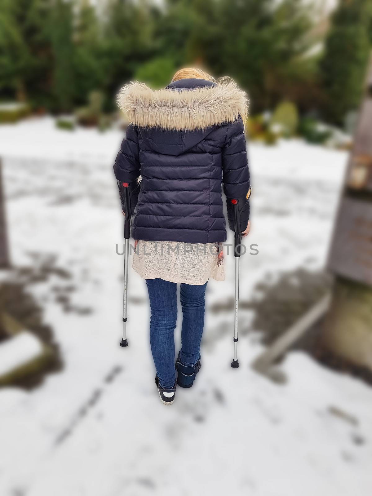 Woman walking on crutches in the park