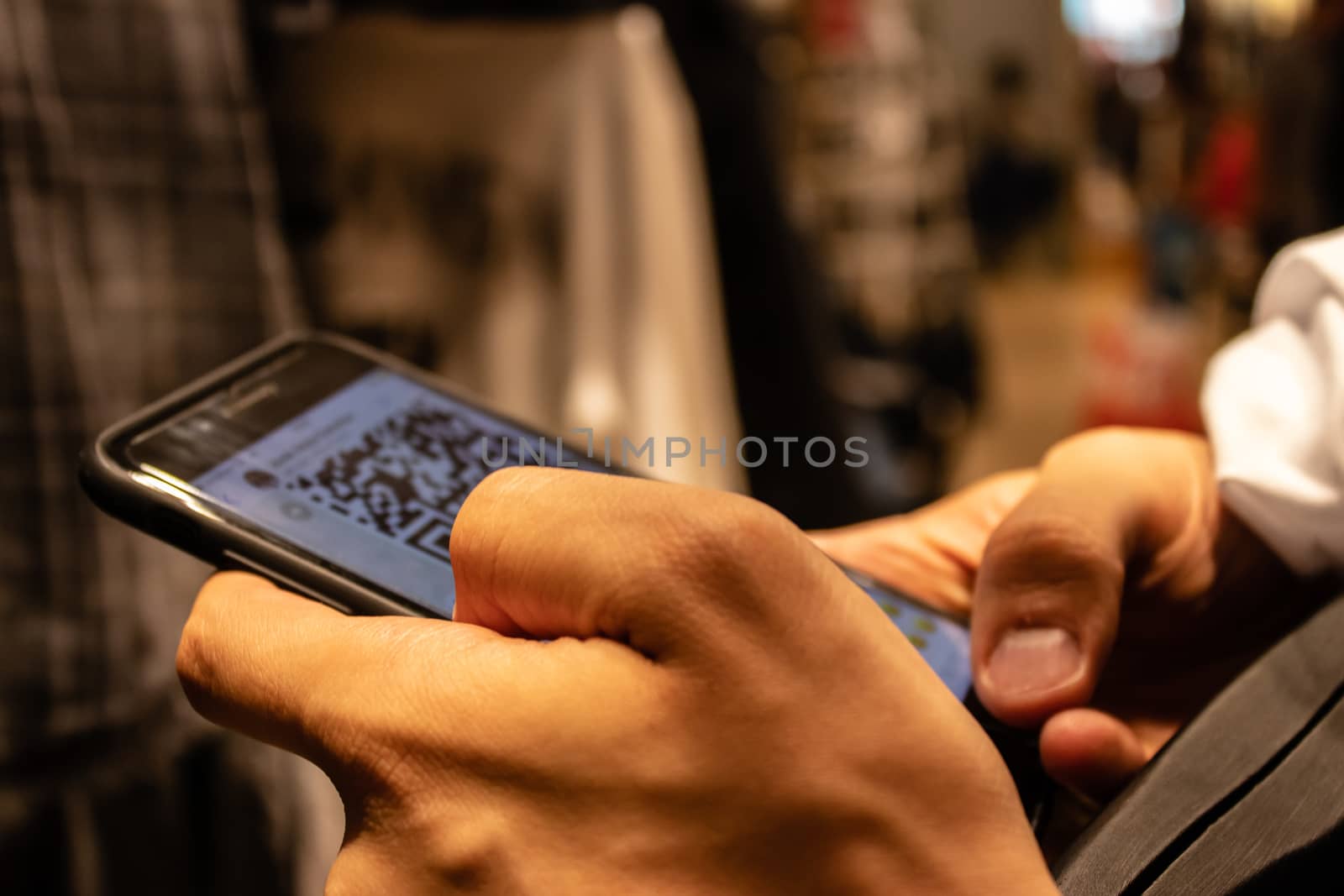 a man holding smartphone and checking something. an isolated concept shoot.