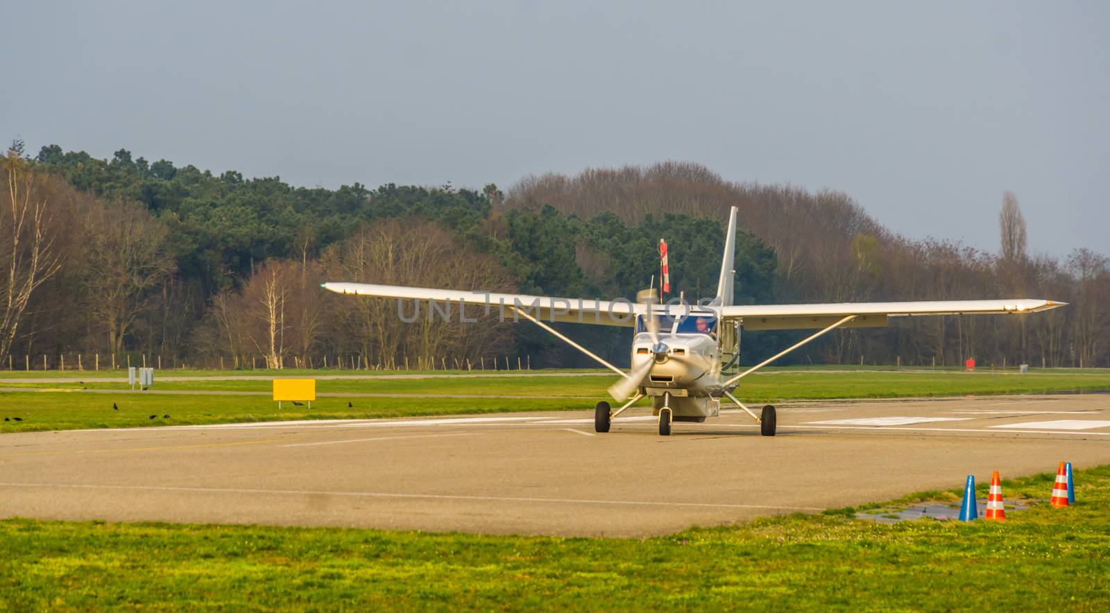 white airplane landing on the air strip, recreational sport and hobby, air transportation by charlottebleijenberg