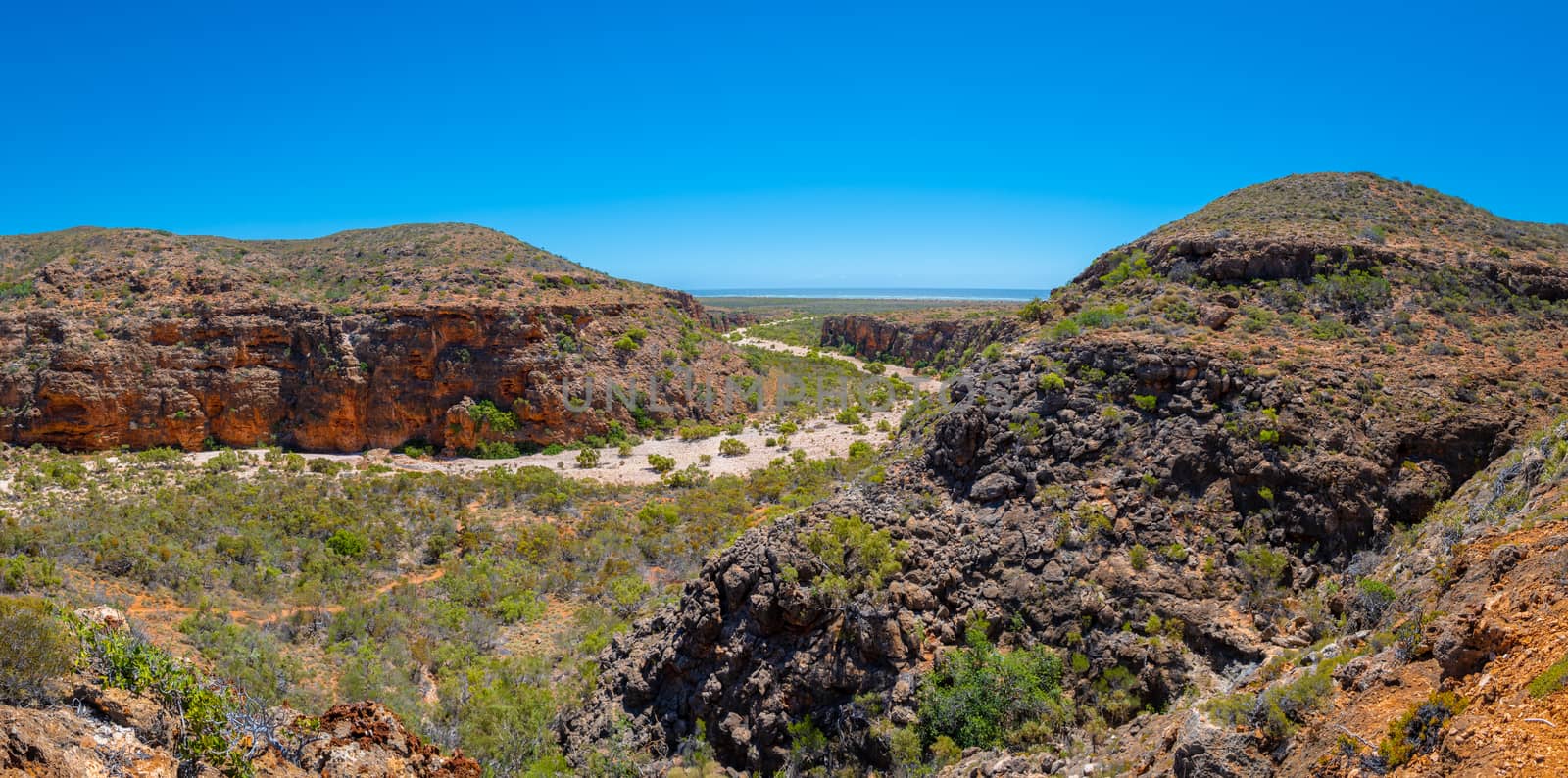 Mandu Mandu Gorge with dry river bed leading into Indian Ocean at Cape Range National Park Australia by MXW_Stock