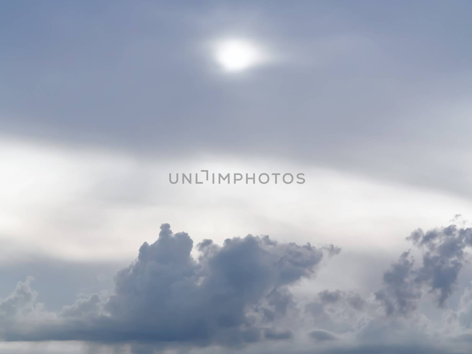 Sun shines through the overcast sky in cloudy weather - image, photo by galsand