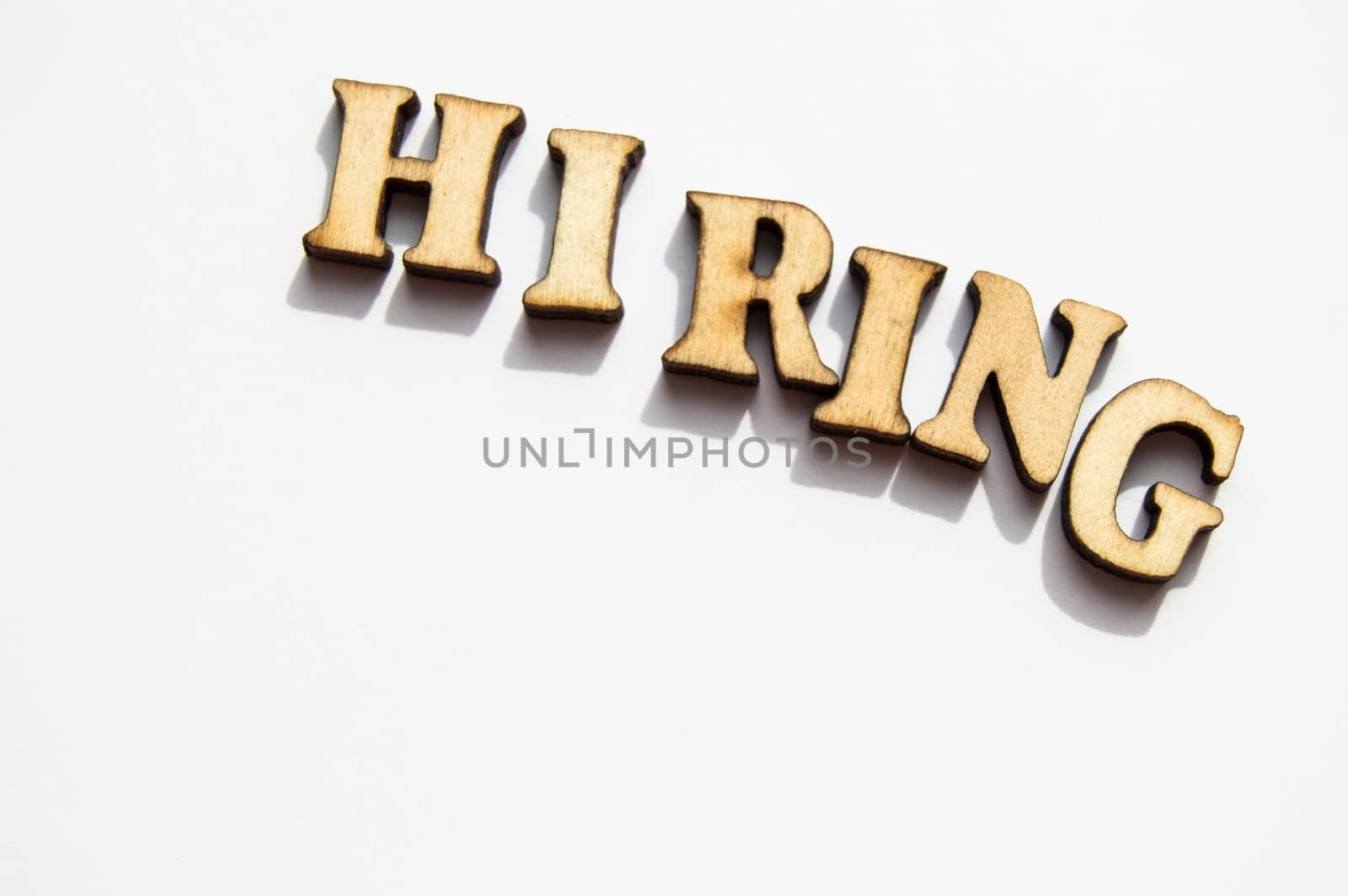 The word hiring is written in gold letters, isolated on white background, copy space, mockup for designer.
