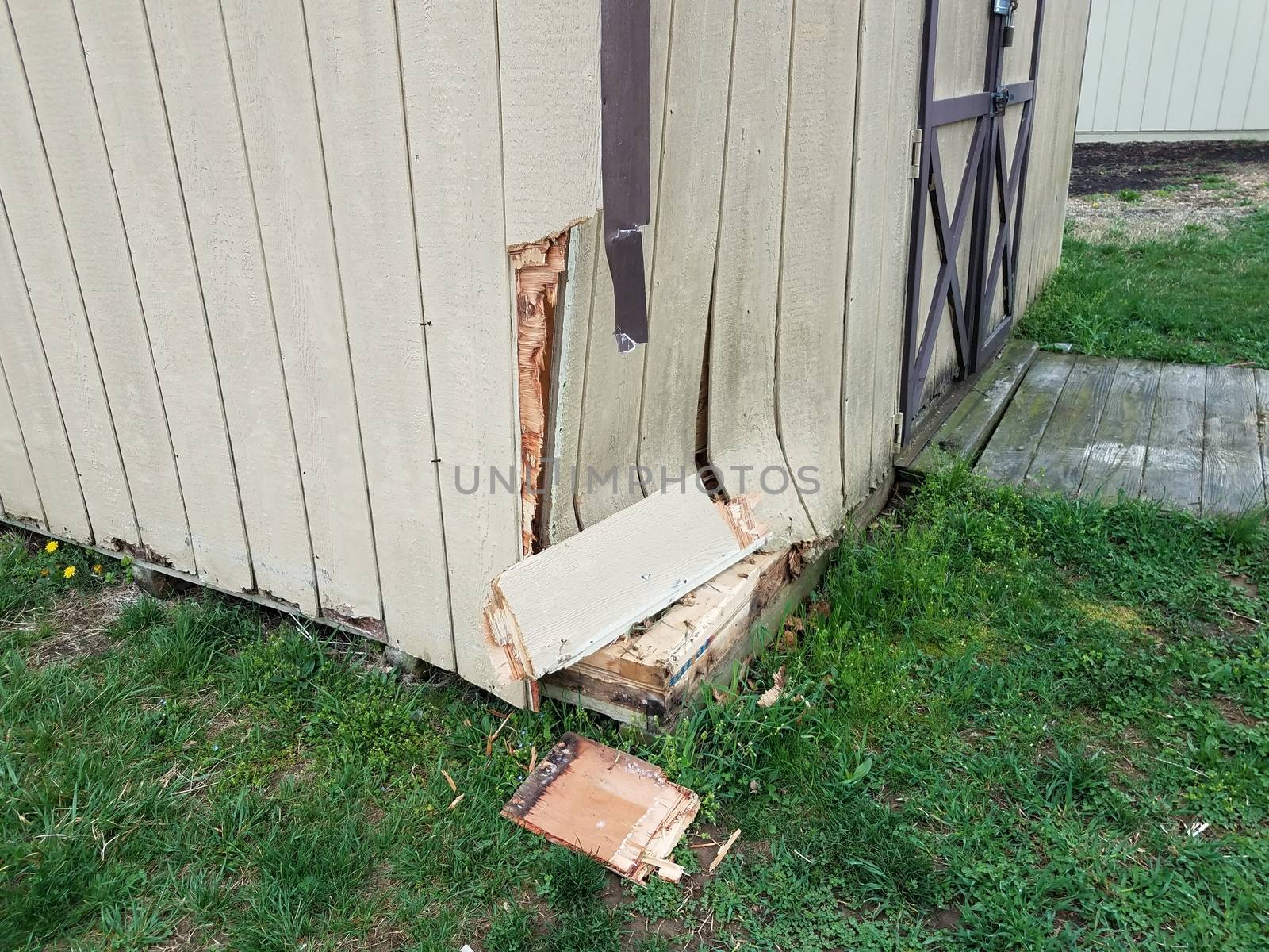 broken wood storage shed or building or structure with damage