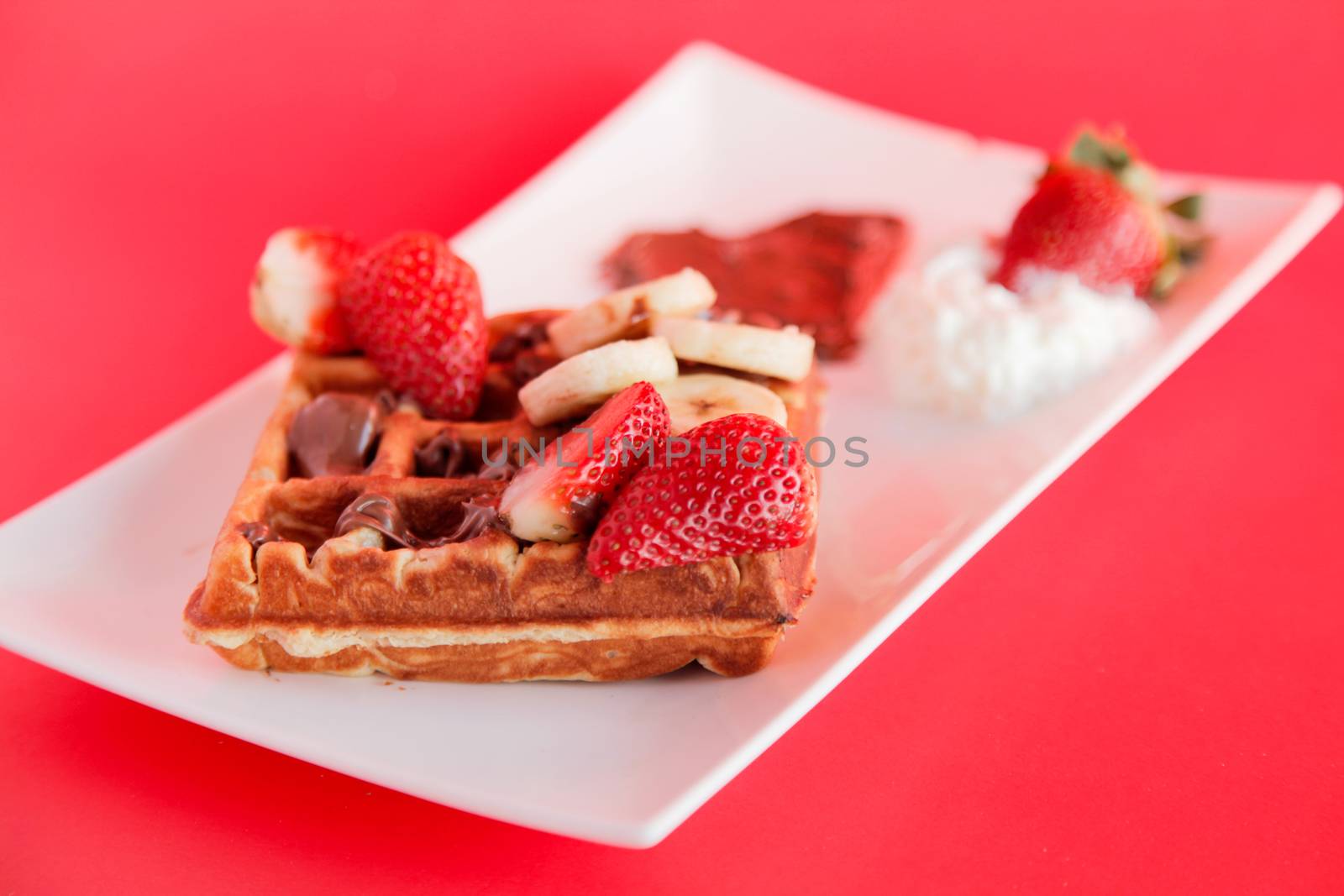 Strawberry and Banana flavour waffle with whipped cream and chocolate spread