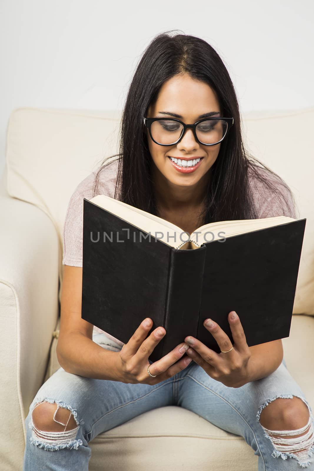 young woman reading a book by mypstudio