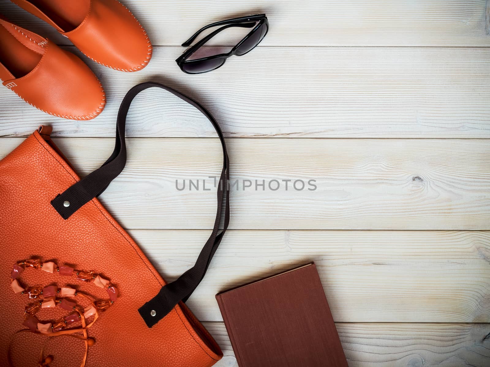 Beach accessories on wooden background. Holidays concept. View from above