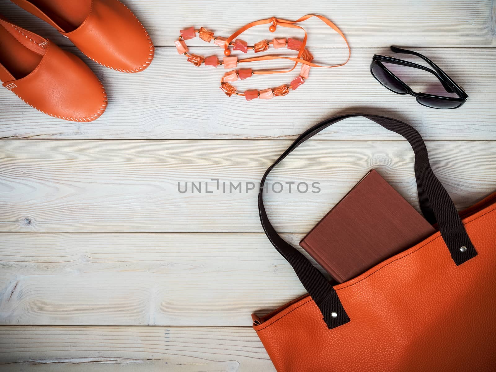 Beach accessories on wooden background. Holidays concept. View from above