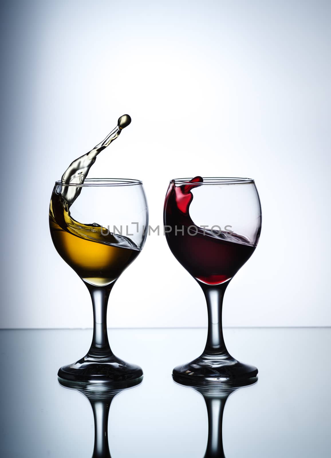 stream of wine being pouring into a glass closeup by dmitry_derenyuk