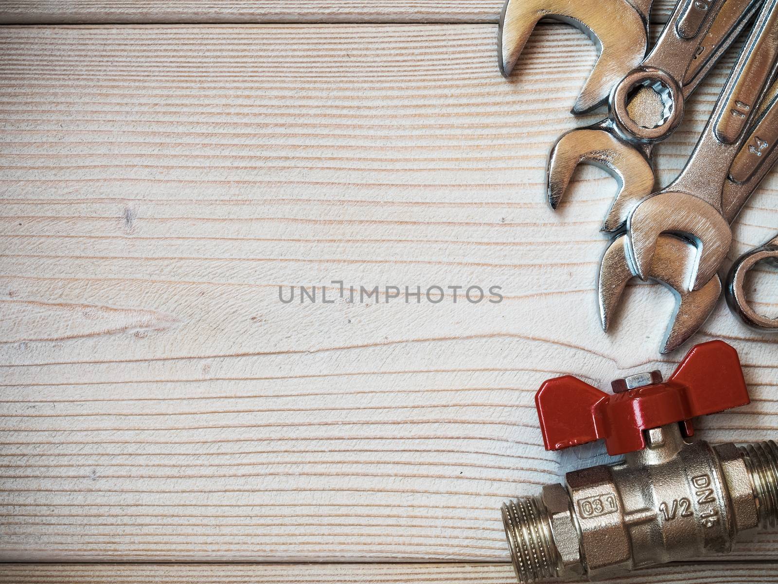 Several spanners on wooden board. Copy space. Plumbing concept