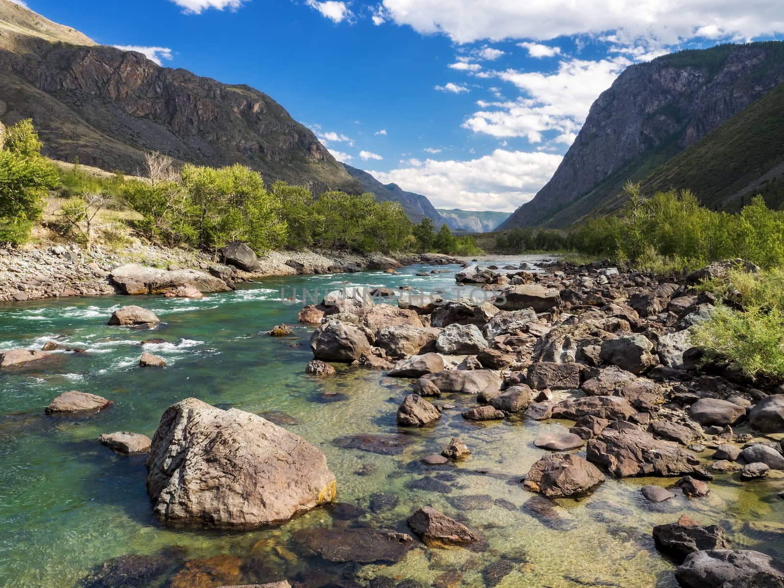 Clear day in the mountains, view from the river shore