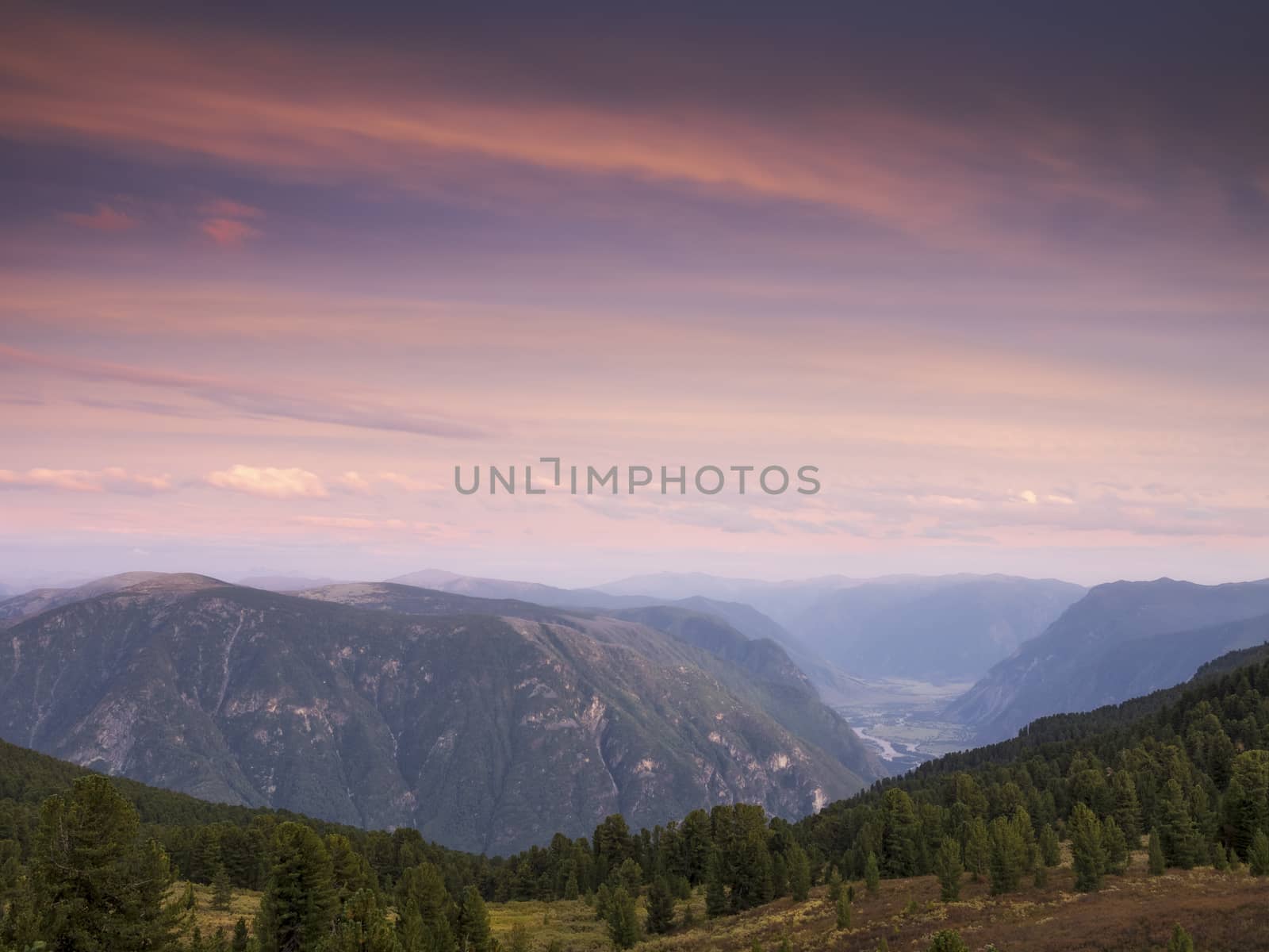 Purple sky over the evening mountains and valleys at sunset